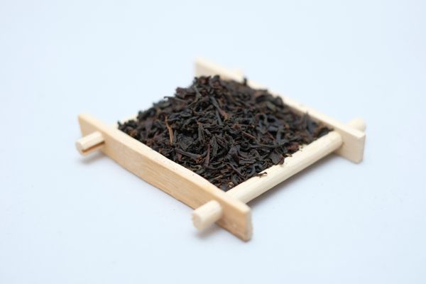 A picture of a Bamboo Coaster filled with Earl Grey Tea Leaves.