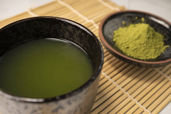 A picture of a teacup full of Matcha Green Tea and Powder by Red Moon Tea.