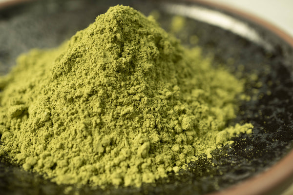 A close up picture of vibrant Matcha Green Tea Powder by Red Moon Tea.